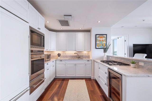 1 Tower Dr Unit 203, Portsmouth, RI 02871 - kitchen with wine cooler, built in appliances, a warming drawer, a sink, and a peninsula