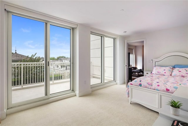 1 Tower Dr Unit 203, Portsmouth, RI 02871 - bedroom with access to exterior, light colored carpet, and baseboards