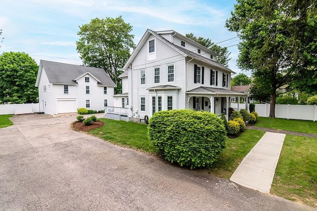 390 Woodruff Ave, South Kingstown, RI 02879 - view of front of property featuring asphalt driveway, a garage, and a porch
