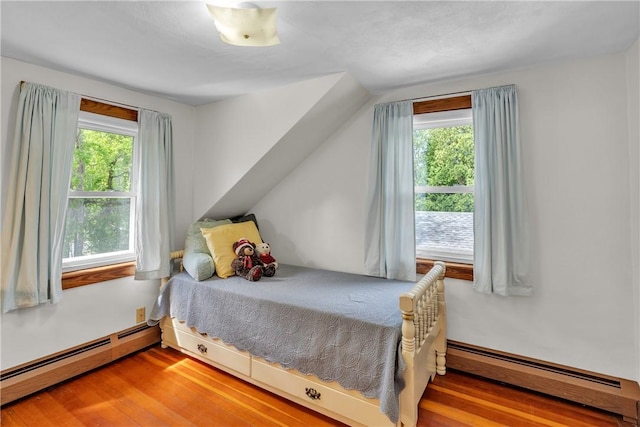 72 Old Danielson Pike, Foster, RI 02825 - bedroom featuring a baseboard heating unit, multiple windows, and wood finished floors