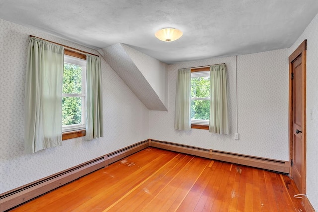 72 Old Danielson Pike, Foster, RI 02825 - additional living space featuring hardwood / wood-style floors, a baseboard heating unit, and wallpapered walls