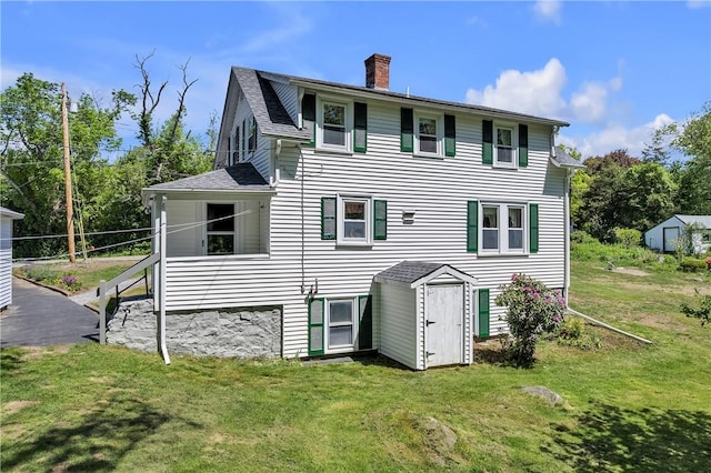 72 Old Danielson Pike, Foster, RI 02825 - rear view of property featuring a chimney, a lawn, and roof with shingles
