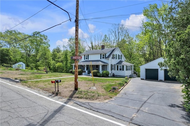 72 Old Danielson Pike, Foster, RI 02825 - view of front of home featuring an outdoor structure, a chimney, a front lawn, and a detached garage
