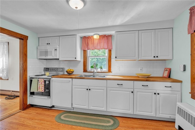 72 Old Danielson Pike, Foster, RI 02825 - kitchen with white appliances, radiator heating unit, a sink, butcher block countertops, and white cabinets