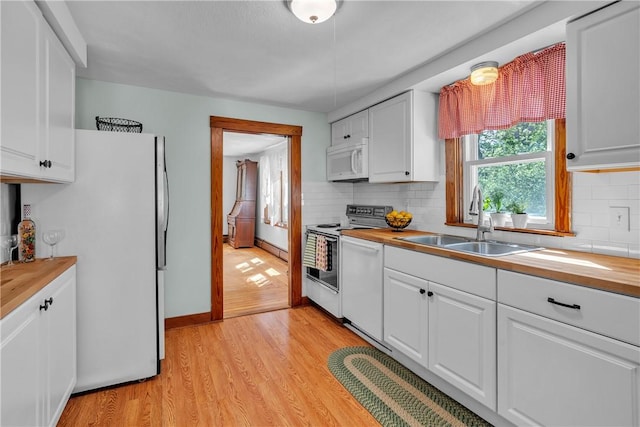 72 Old Danielson Pike, Foster, RI 02825 - kitchen featuring white appliances, butcher block countertops, a sink, light wood-style flooring, and decorative backsplash