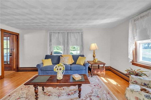 72 Old Danielson Pike, Foster, RI 02825 - living room with plenty of natural light, wood finished floors, baseboard heating, and baseboards