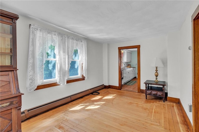 72 Old Danielson Pike, Foster, RI 02825 - spare room featuring a baseboard heating unit, light wood-type flooring, and baseboards