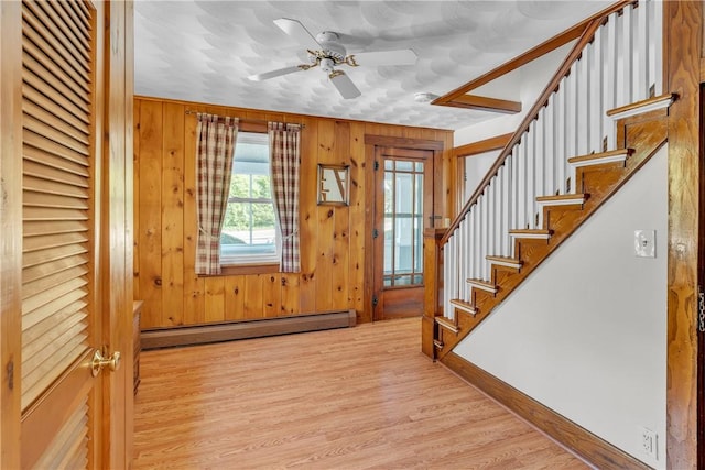 72 Old Danielson Pike, Foster, RI 02825 - entryway with baseboard heating, a ceiling fan, wood finished floors, stairs, and baseboards