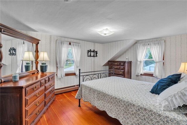 72 Old Danielson Pike, Foster, RI 02825 - bedroom featuring wallpapered walls, a baseboard radiator, hardwood / wood-style floors, and multiple windows