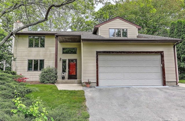 9 Misty River Ter, Narragansett, RI 02874 - view of front of property with asphalt driveway, a garage, and a chimney