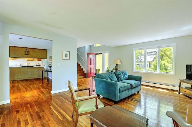 9 Misty River Ter, Narragansett, RI 02874 - living area with stairs, wood finished floors, a baseboard heating unit, and baseboards