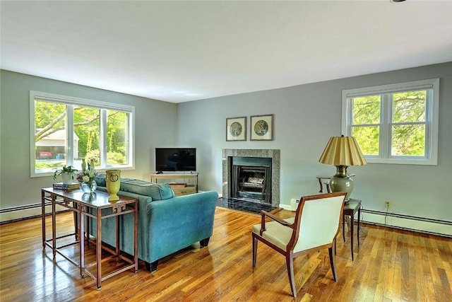 9 Misty River Ter, Narragansett, RI 02874 - living area with a baseboard heating unit, a fireplace, wood finished floors, and a baseboard radiator