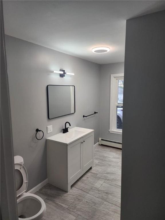 45 Ross St, Woonsocket, RI 02895 - half bathroom featuring a baseboard radiator, baseboards, vanity, and toilet