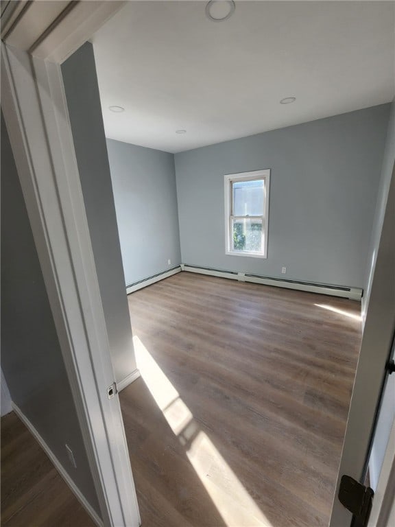45 Ross St, Woonsocket, RI 02895 - spare room featuring wood finished floors, a baseboard heating unit, baseboards, and recessed lighting