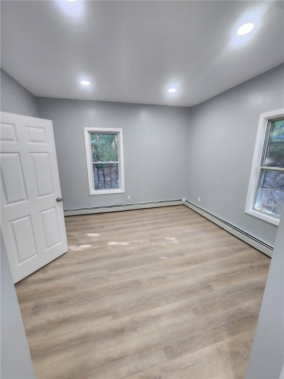 45 Ross St, Woonsocket, RI 02895 - empty room with baseboard heating, wood finished floors, and recessed lighting