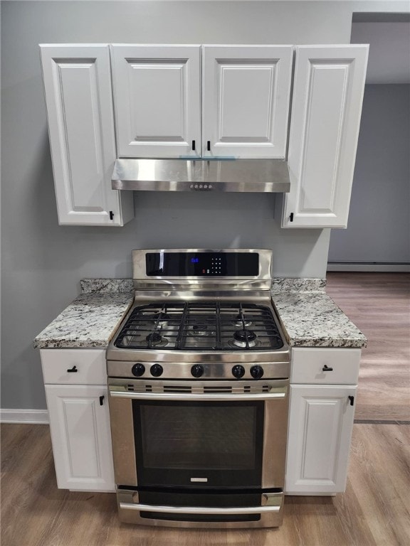 45 Ross St, Woonsocket, RI 02895 - kitchen with stainless steel range with gas cooktop, under cabinet range hood, white cabinetry, light wood finished floors, and light stone countertops