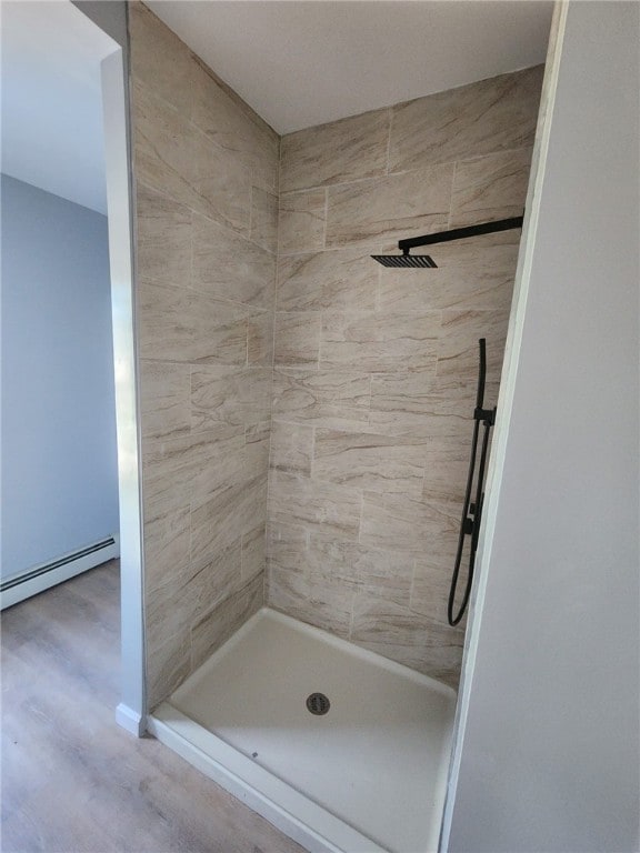 45 Ross St, Woonsocket, RI 02895 - bathroom with a stall shower, a baseboard heating unit, and wood finished floors