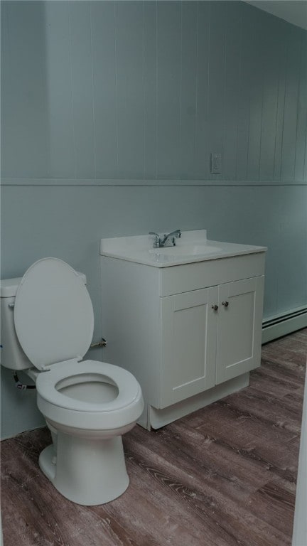 45 Ross St, Woonsocket, RI 02895 - bathroom featuring a baseboard radiator, wood finished floors, toilet, and vanity