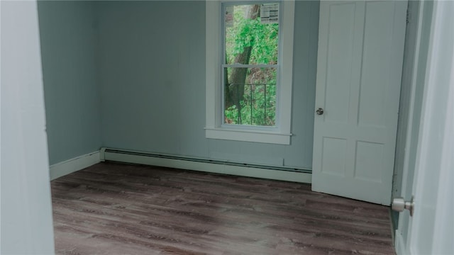 45 Ross St, Woonsocket, RI 02895 - empty room featuring baseboard heating, dark wood-style floors, plenty of natural light, and baseboards
