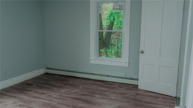 45 Ross St, Woonsocket, RI 02895 - spare room featuring a baseboard radiator, dark wood-style flooring, and plenty of natural light