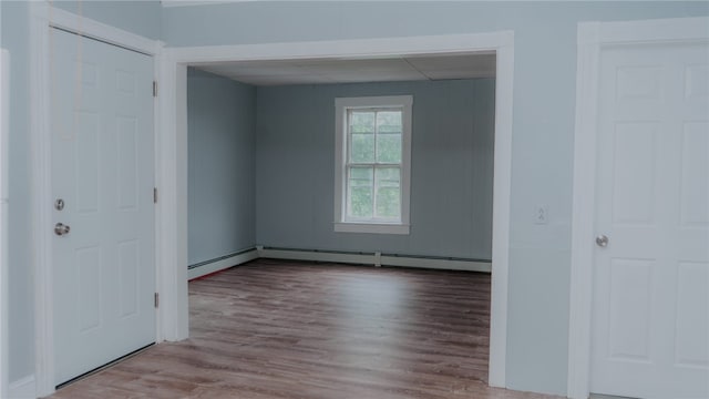 45 Ross St, Woonsocket, RI 02895 - unfurnished bedroom with a baseboard radiator, wood finished floors, and baseboards