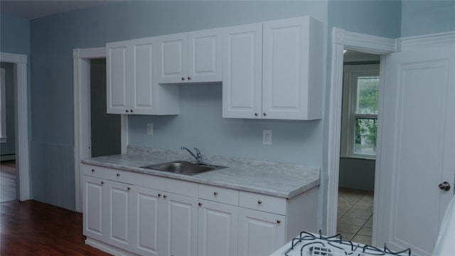 45 Ross St, Woonsocket, RI 02895 - kitchen with a sink, light countertops, and white cabinets