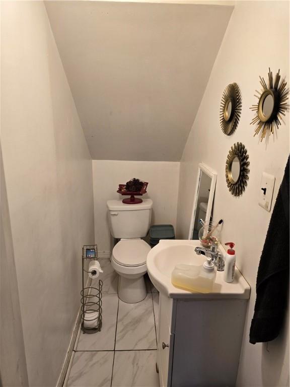 20 Pennsyjvania Ave, Providence, RI 02905 - half bathroom featuring vanity, toilet, lofted ceiling, and marble finish floors
