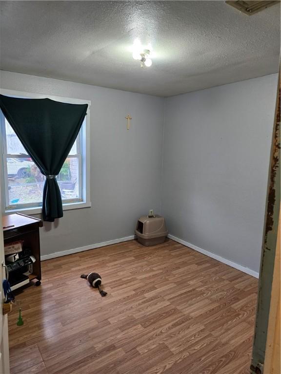 20 Pennsyjvania Ave, Providence, RI 02905 - empty room with wood finished floors, a textured ceiling, and baseboards