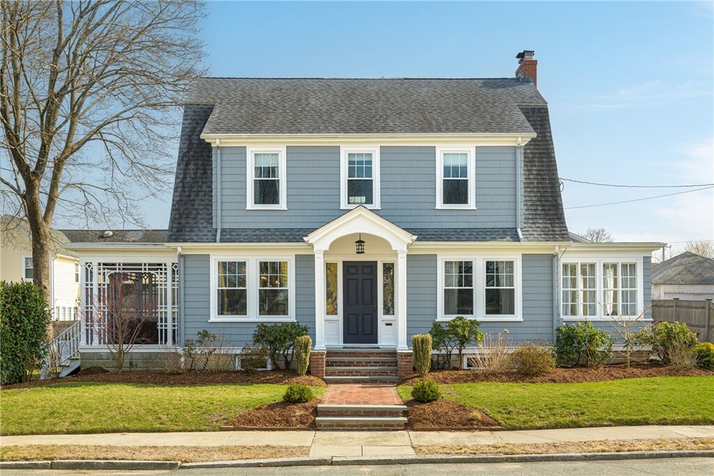 15 Rosewood Ave, Cranston, RI 02905 - dutch colonial featuring a chimney and roof with shingles