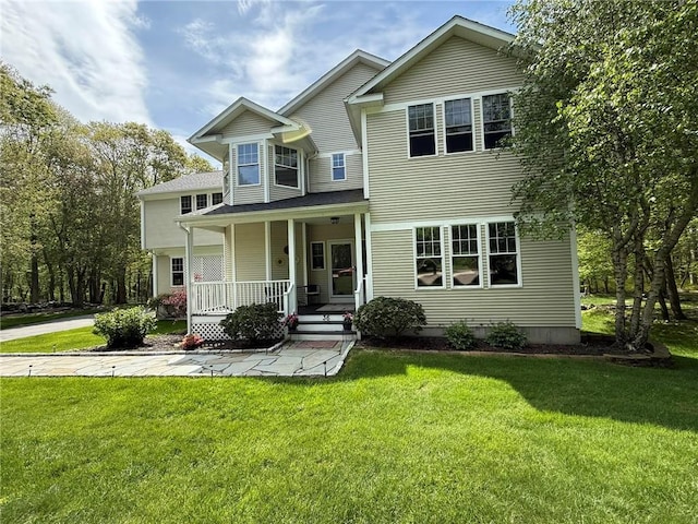 36 Jasmine Cir, North Kingstown, RI 02874 - view of front of house with covered porch and a front yard