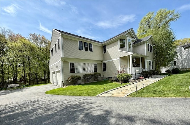 36 Jasmine Cir, North Kingstown, RI 02874 - colonial home with covered porch, an attached garage, concrete driveway, and a front lawn