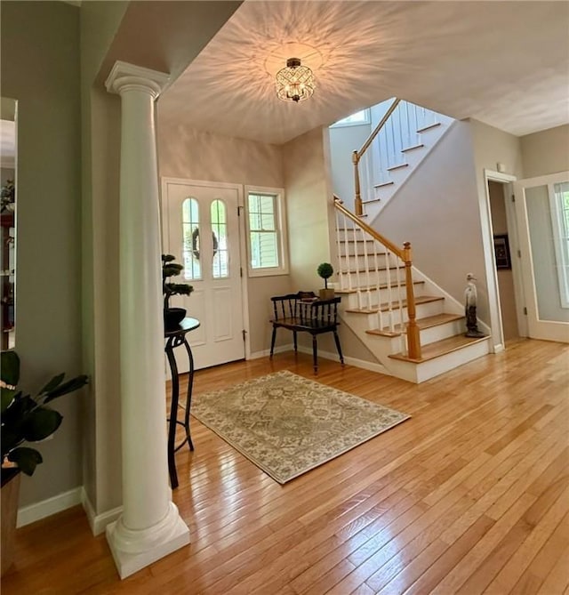 36 Jasmine Cir, North Kingstown, RI 02874 - entrance foyer with decorative columns, stairway, hardwood / wood-style floors, and baseboards