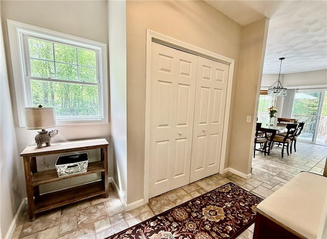 36 Jasmine Cir, North Kingstown, RI 02874 - foyer with baseboards, a chandelier, and a textured ceiling