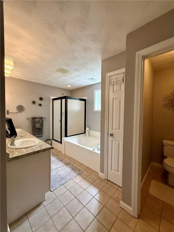 36 Jasmine Cir, North Kingstown, RI 02874 - bathroom with tile patterned floors, a bath, a stall shower, and toilet