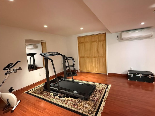 36 Jasmine Cir, North Kingstown, RI 02874 - workout room featuring an AC wall unit, wood finished floors, baseboards, a wall mounted air conditioner, and recessed lighting