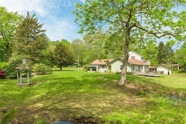 140 Baycliff Dr, Warwick, RI 02818 - view of green lawn featuring a wooden deck and view of wooded area