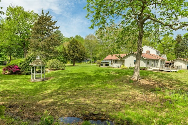 140 Baycliff Dr, Warwick, RI 02818 - view of green lawn with a deck and view of scattered trees