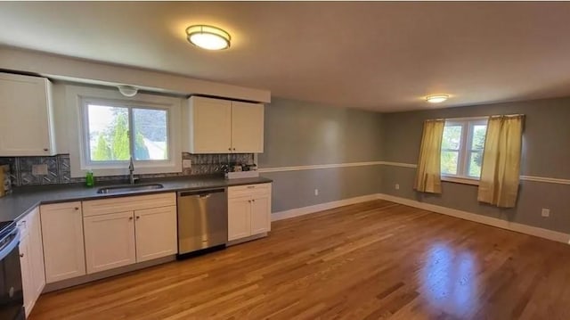 132 Maple Ave, Middletown, RI 02842 - kitchen featuring dishwasher, a sink, light wood-style floors, and backsplash
