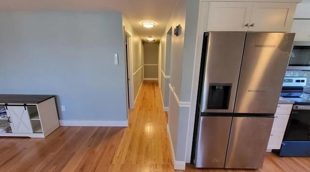 132 Maple Ave, Middletown, RI 02842 - kitchen with stainless steel appliances, white cabinetry, light wood-type flooring, and baseboards