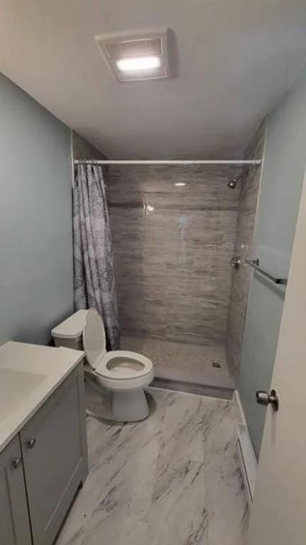 132 Maple Ave, Middletown, RI 02842 - full bath with marble look tiles, tiled shower, vanity, and toilet