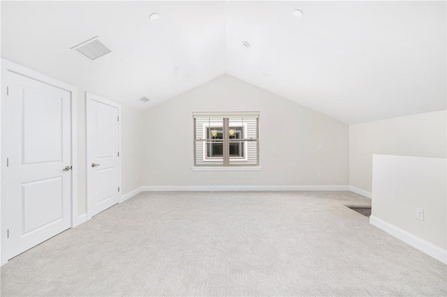 81 W Valley Cir, West Warwick, RI 02893 - additional living space with light carpet, lofted ceiling, and baseboards