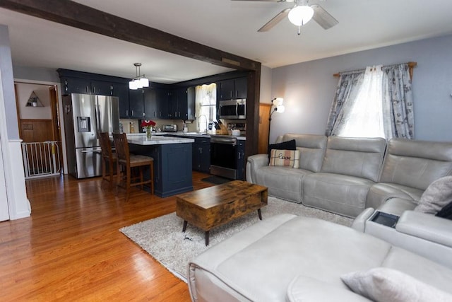 60 Sumach Ave, East Providence, RI 02915 - living room featuring a ceiling fan, light wood-style flooring, and beamed ceiling