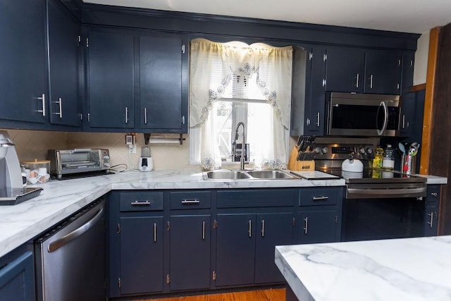 60 Sumach Ave, East Providence, RI 02915 - kitchen with appliances with stainless steel finishes, a sink, blue cabinets, and light countertops