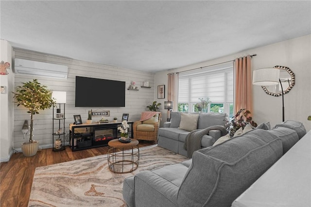 52 Eddy St, North Providence, RI 02911 - living area featuring a wall unit AC, wood finished floors, wooden walls, a glass covered fireplace, and baseboards