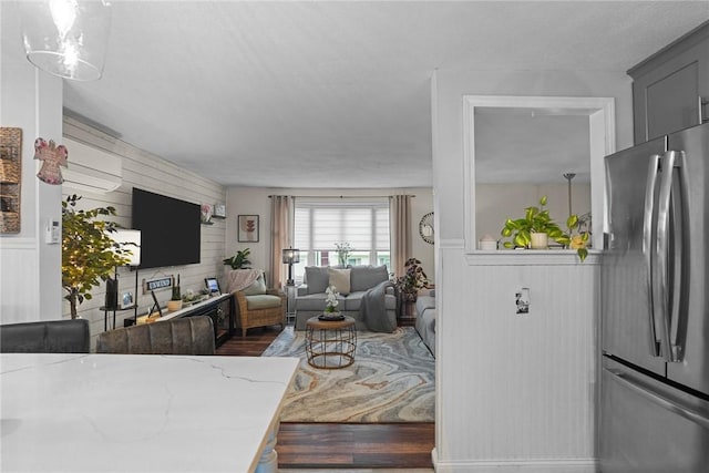 52 Eddy St, North Providence, RI 02911 - living area with wooden walls, wood finished floors, and a wall mounted air conditioner