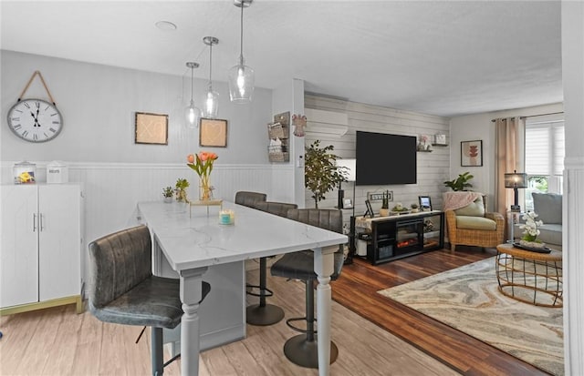 52 Eddy St, North Providence, RI 02911 - dining space with wood finished floors, wainscoting, and wooden walls