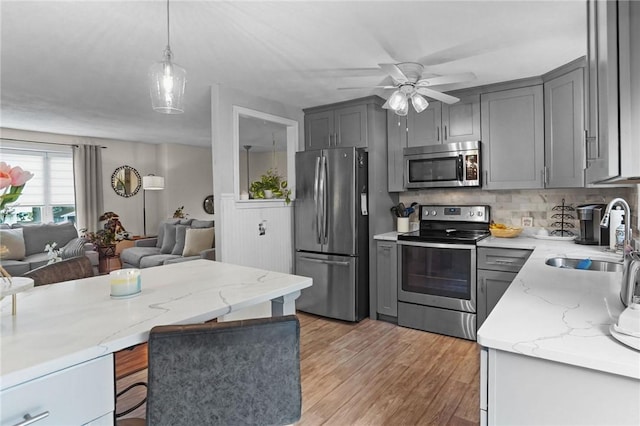 52 Eddy St, North Providence, RI 02911 - kitchen featuring appliances with stainless steel finishes, a sink, gray cabinetry, and open floor plan