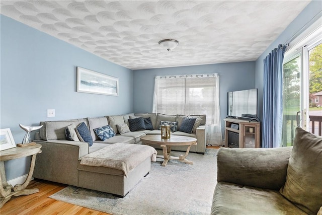 27 Aberdeen St, West Warwick, RI 02893 - living room featuring wood finished floors, a textured ceiling, and baseboards