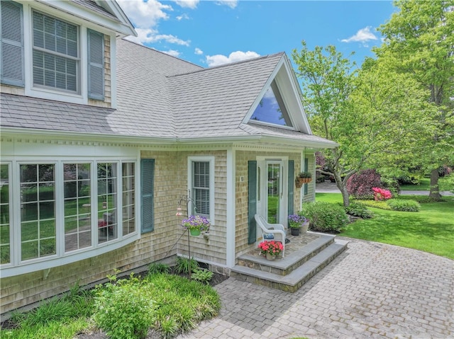10 Bartlett Rd, Middletown, RI 02842 - property entrance featuring a shingled roof and a lawn