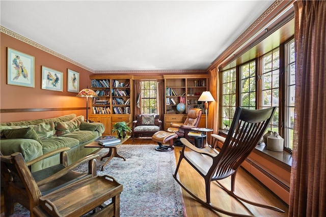 10 Bartlett Rd, Middletown, RI 02842 - sitting room with wood finished floors, crown molding, baseboard heating, and built in features